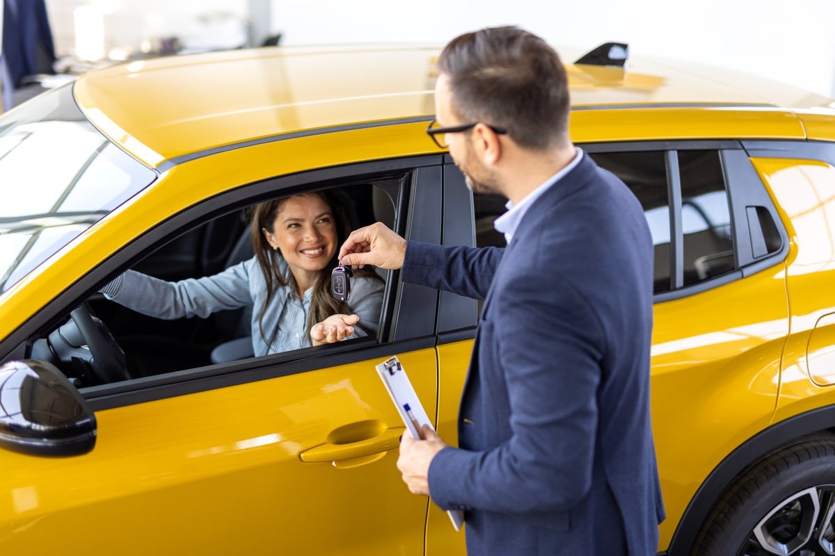 A gig driver receiving the keys to their rental vehicle at a Northgate Rentals counter