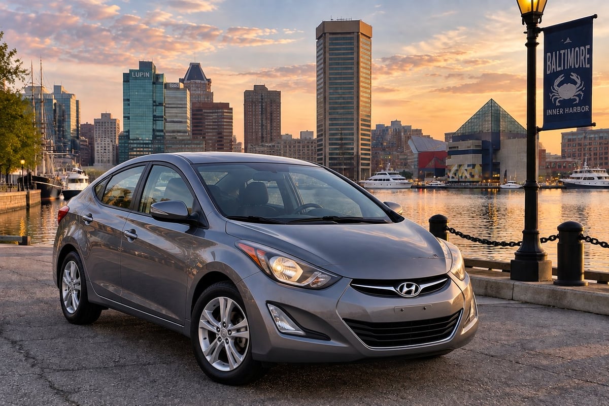 Silver Hyundai Elantra sedan parked on the Baltimore waterfront promenade with the Inner Harbor skyline at sunset
